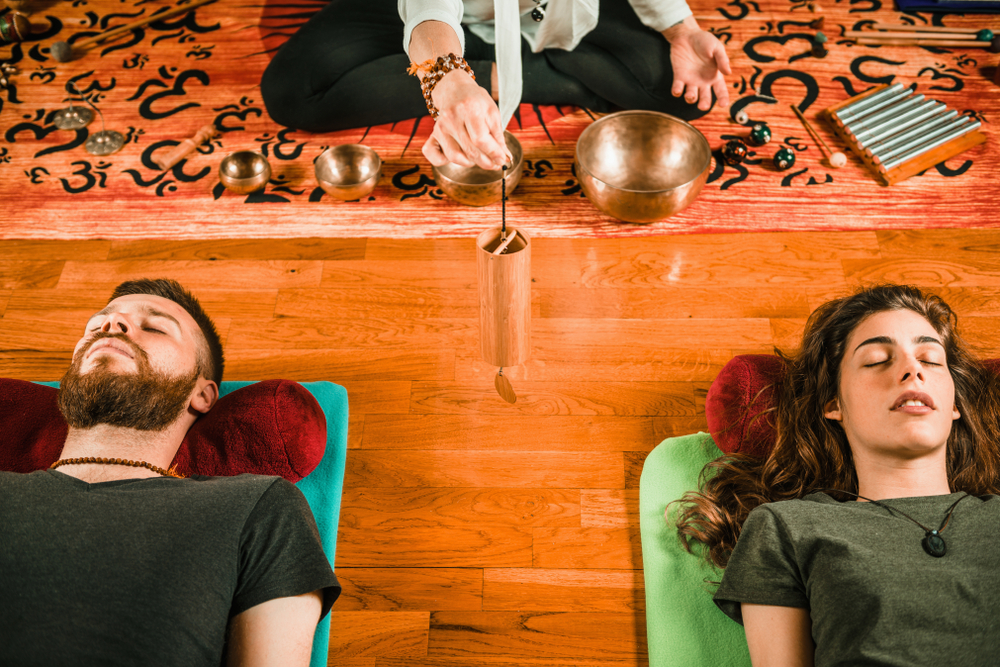 Man and woman participate in a Couples Sound Bath to connect on a deeper and more intimate level